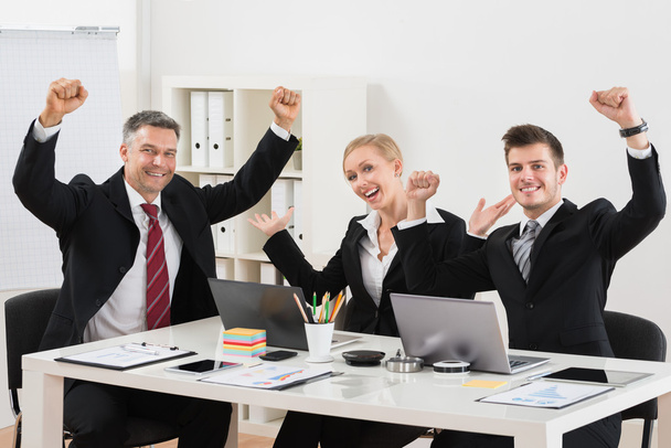 Happy Businesspeople With Arm Raised In Office - Fotografie, Obrázek