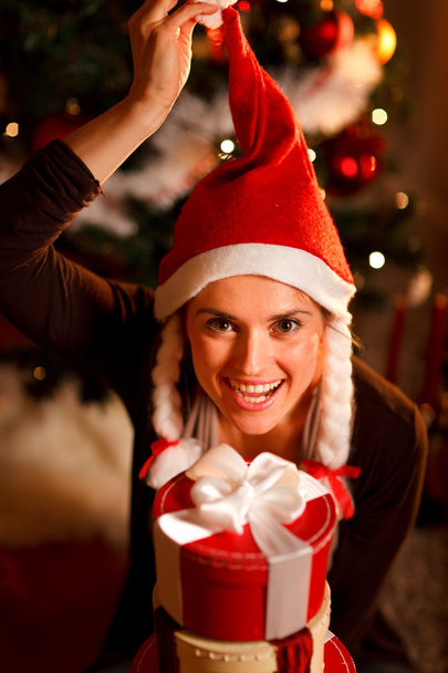 Funny portrait of happy woman near Christmas tree - Fotó, kép