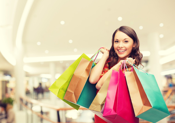 smiling young woman with shopping bags - Foto, immagini
