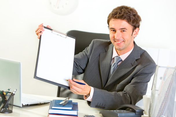 Smiling businessman giving clipboard and pen for signing - Foto, Imagem