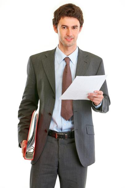 Modern businessman with folder and document in hand - Фото, зображення