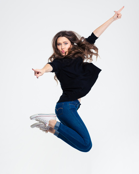 Portrait of a beautiful casual woman jumping - 写真・画像