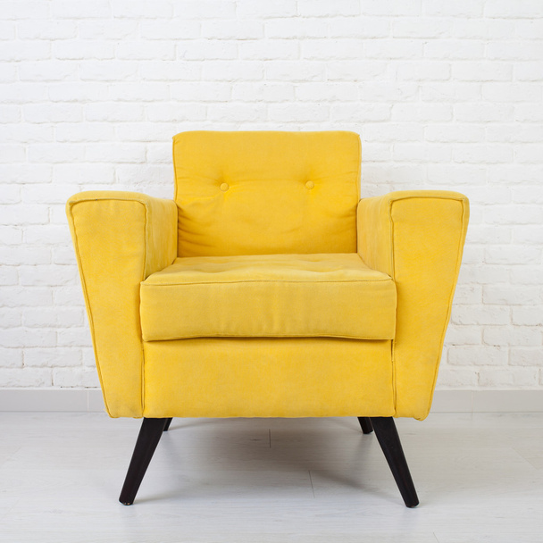 White wall texture with a retro yellow armchair - Fotoğraf, Görsel