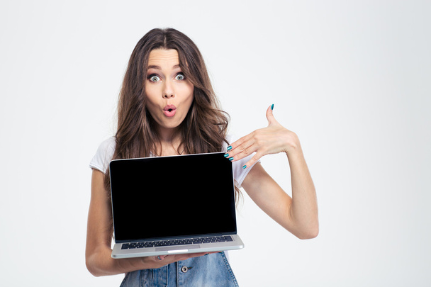 Woman pointing finger on blank laptop computer screen - Foto, Imagem