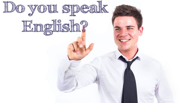 Do you speak English? - Young smiling businessman touching text - Foto, imagen