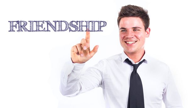 FRIENDSHIP - Young smiling businessman touching text - Zdjęcie, obraz