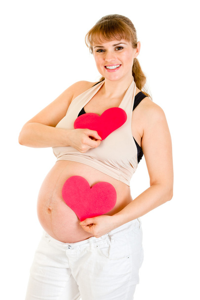 Happy pregnant woman holding two paper hearts in hands. Concept - two heart - Fotoğraf, Görsel