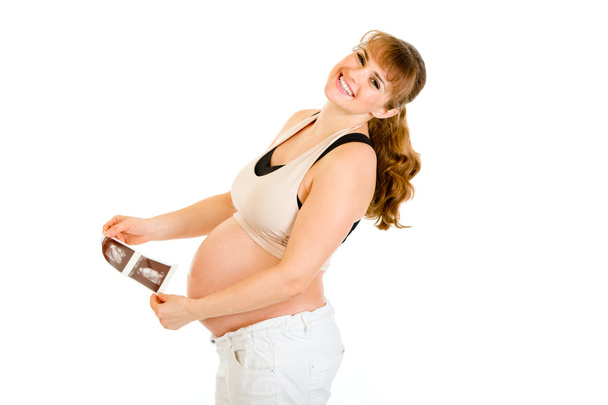 Laughing pregnant woman holding echo in hands - Фото, зображення