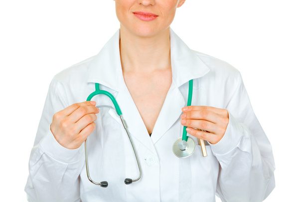 Medical doctor woman straightening stethoscope. Close-up. - Photo, Image