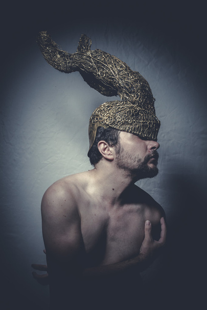 Naked man with helmet warrior trumpets - Foto, afbeelding