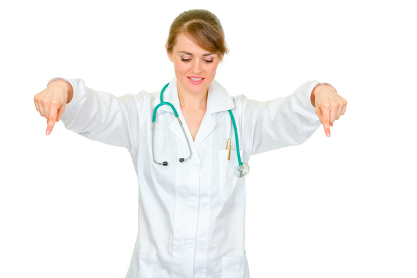 Medical doctor woman pointing down - Фото, зображення