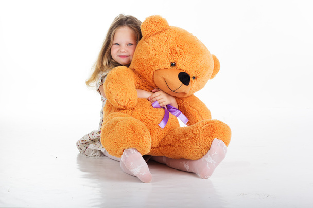 Child girl is hugging her teddy bear - Zdjęcie, obraz