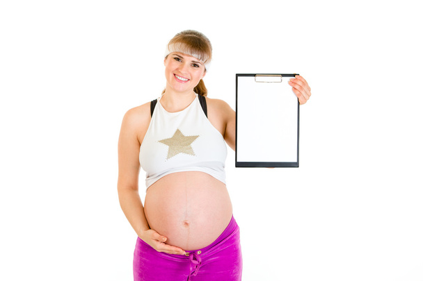 Smiling beautiful pregnant woman holding blank clipboard in hands - Fotografie, Obrázek