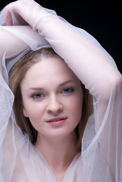 Closeup portrait of beautiful blond girl in white fabric - Photo, Image