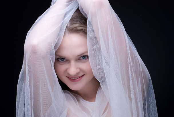 Closeup portrait of beautiful blond girl in white fabric - Φωτογραφία, εικόνα