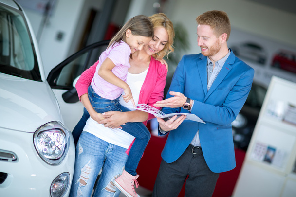 Young smiling mom in car showroom - Photo, image