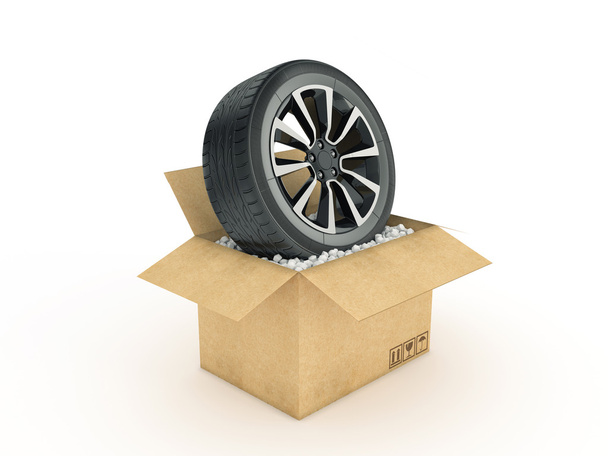 wheel in cardboard box - Foto, imagen