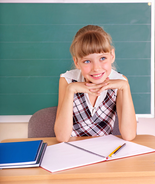 Schoolchild in classroom near blackboard. - Foto, afbeelding