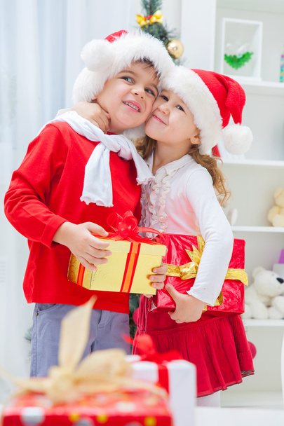 Little boy and girl in Santa outfits - Foto, imagen