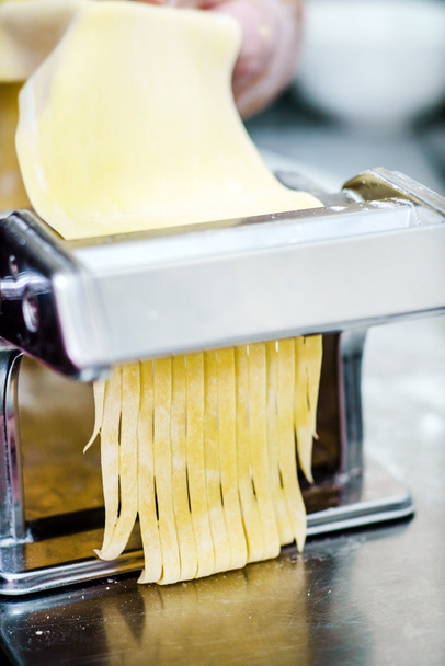 chef making pasta on noodle cutter - Foto, Imagem
