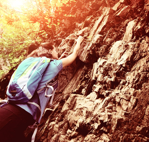 Hiker with backpack climbing on the mountain - Foto, imagen