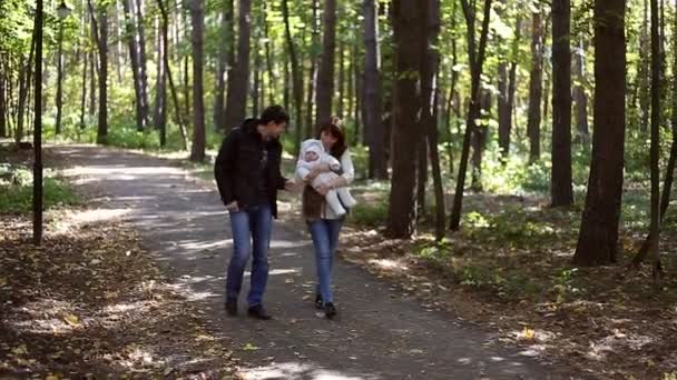 Family with child go in autumn park - Footage, Video