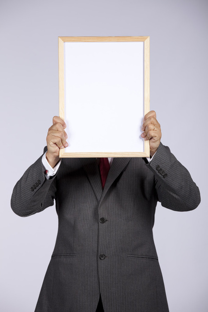 Businessman holding a whiteboard - Photo, image