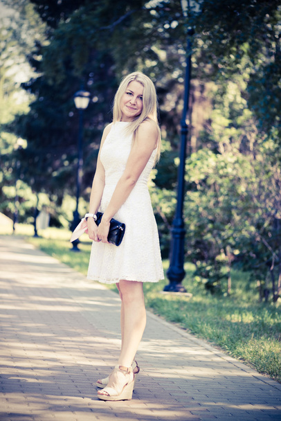 blond woman in a white dress outdoors - Foto, Imagem