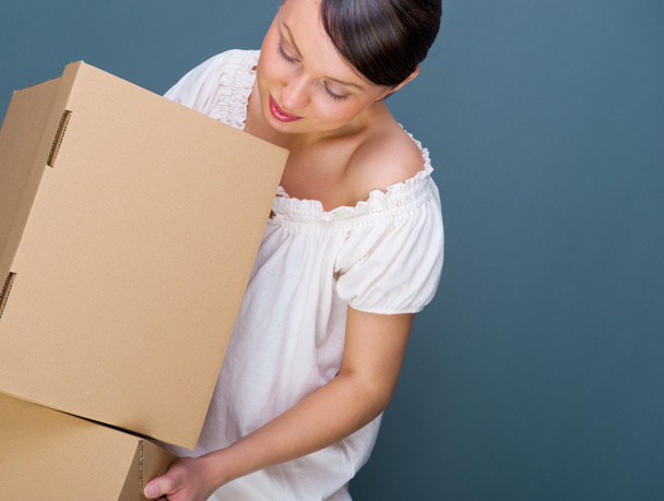 Closeup portrait of a young woman with boxes - Foto, Imagen