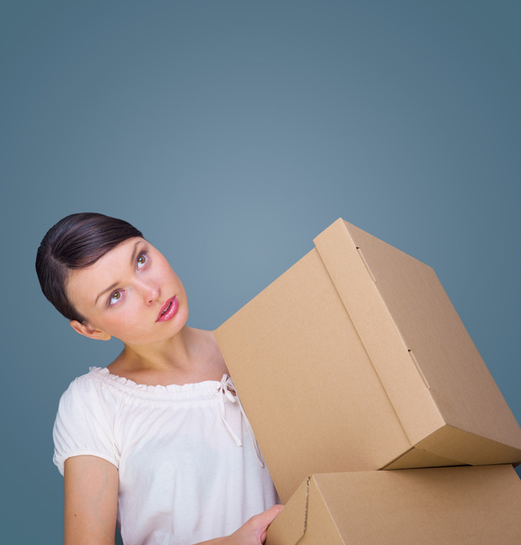 Closeup portrait of a young woman with boxes - Фото, изображение