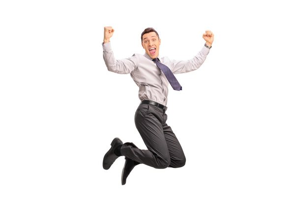 Overjoyed businessman jumping out of joy - 写真・画像