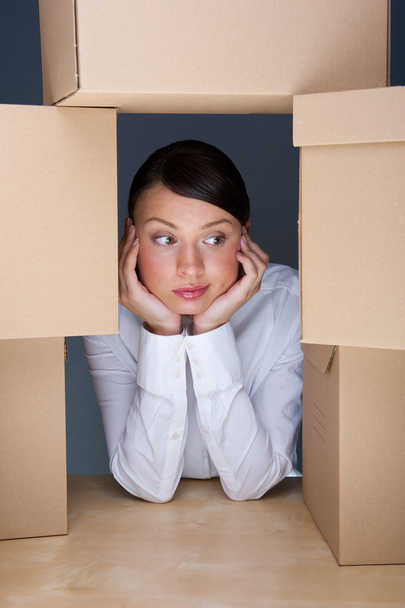 Portrait of young woman surrounded by lots of boxes. Lots of wor - Fotó, kép