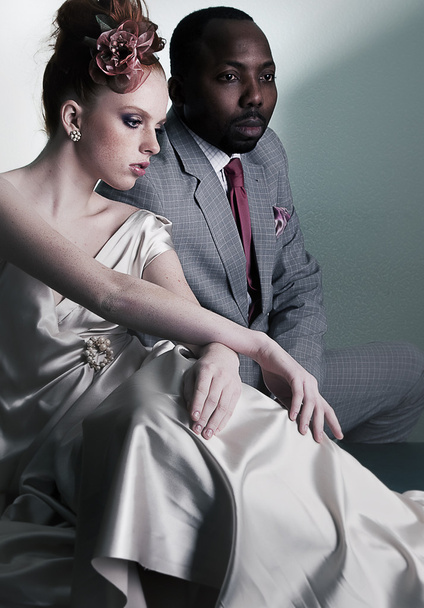 Two fashion models sitting - black man and redhair woman - Photo, Image