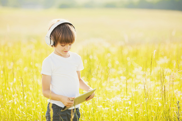 Little boy with tablet on nature - Photo, Image