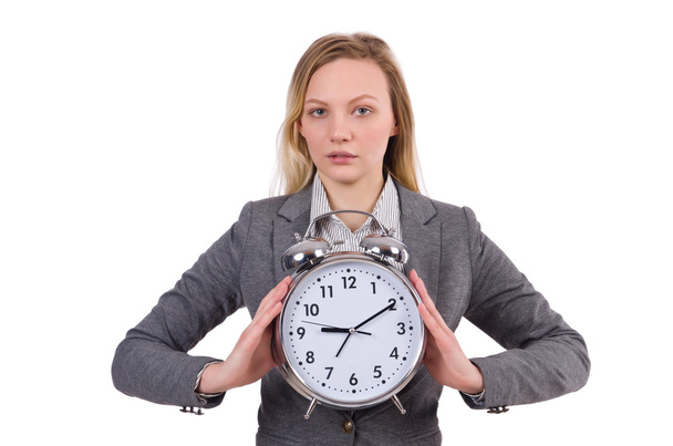 Mujer de negocios en traje gris con reloj despertador aislado en blanco
 - Foto, imagen