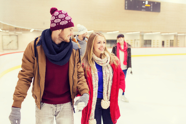happy friends on skating rink - Photo, Image