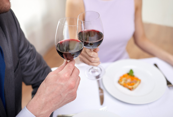young couple with glasses of wine at restaurant - Photo, image
