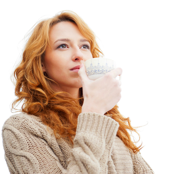 Portrait of beautiful red hair girl drinking coffee on winter ba - Foto, immagini