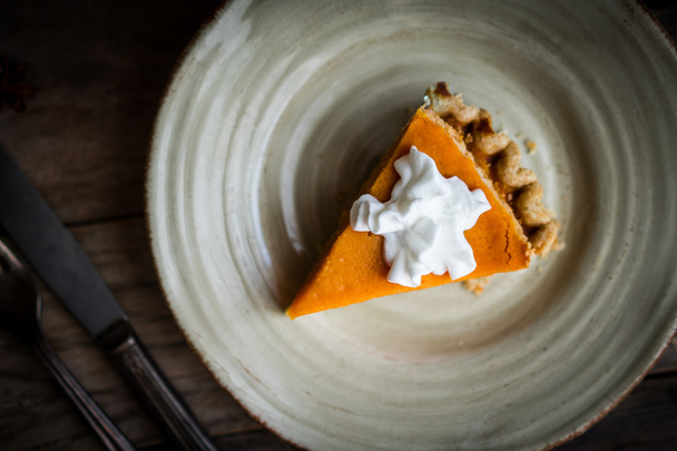 Pumpkin pie on rustic wooden background - Fotó, kép