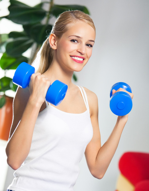 Woman exercising with dumbbells, at home - Foto, Imagem