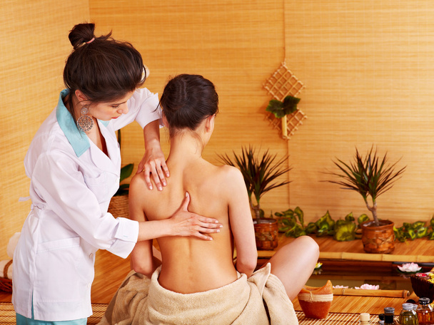 vrouw krijgen massage in bamboe spa. - Foto, afbeelding