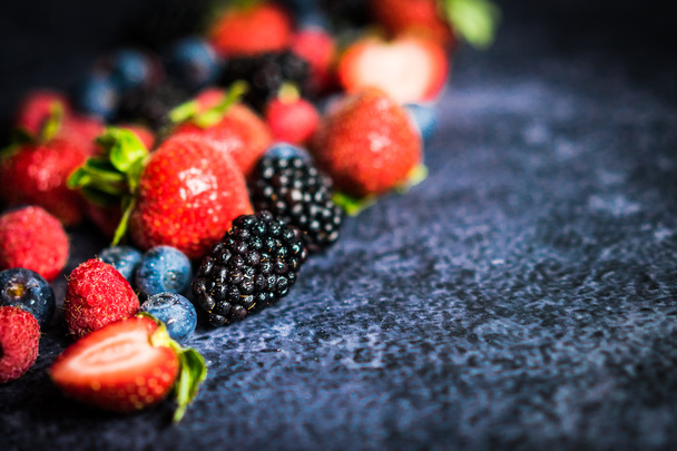 Berry mix on rustic black background - Photo, Image