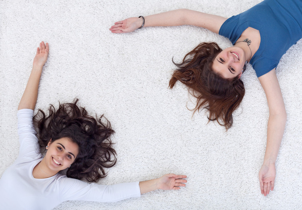 Happy frame - teenagers laying on the floor - Zdjęcie, obraz