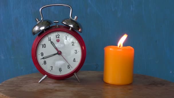 Alarm clock with a burning candle  - Footage, Video