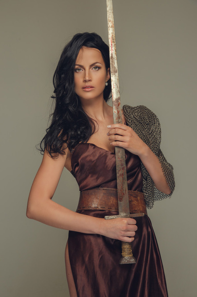 Beautiful brunette woman in ancient dress. - Photo, Image