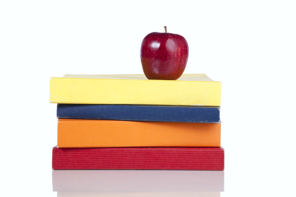 Books and a fresh apple - Фото, изображение