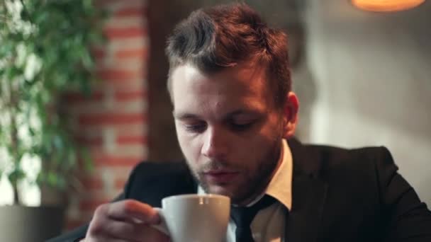 business man drinking coffee in cafe - Materiaali, video