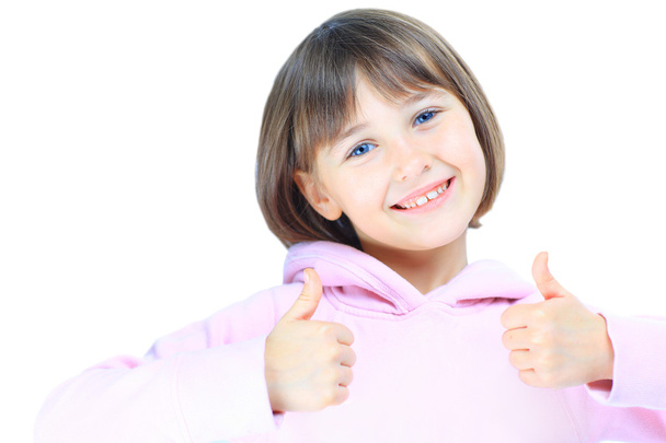 Young beautiful girl child shows thumb up. Isolated on white ba - Фото, изображение