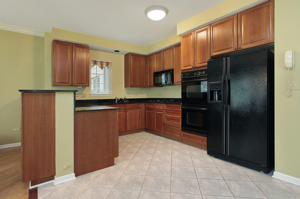Kitchen with black appliances - Photo, Image