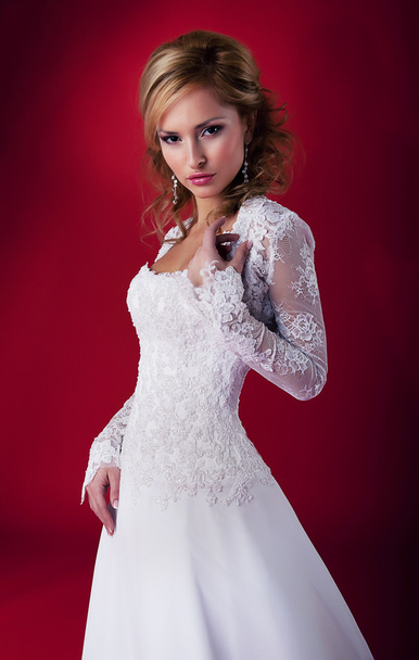 Stylish pretty woman in bridal white dress posing in studio - Fotoğraf, Görsel